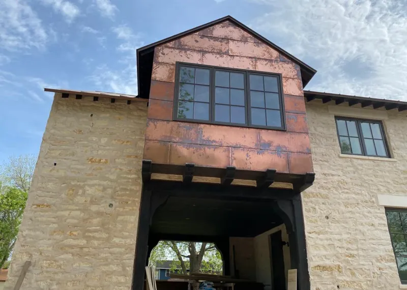 Copper metal panel facade on a stone building for Metal Roof Coating in Childress