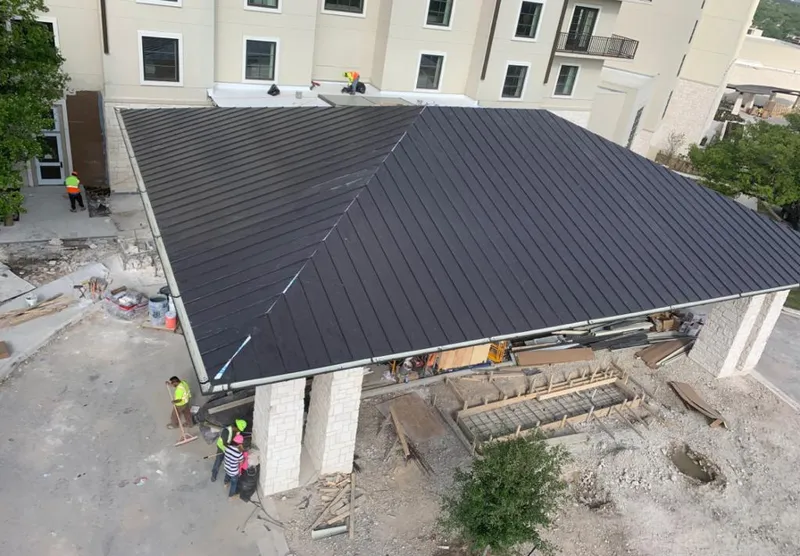 Metal roofing installation team working on a commercial building in Childress
