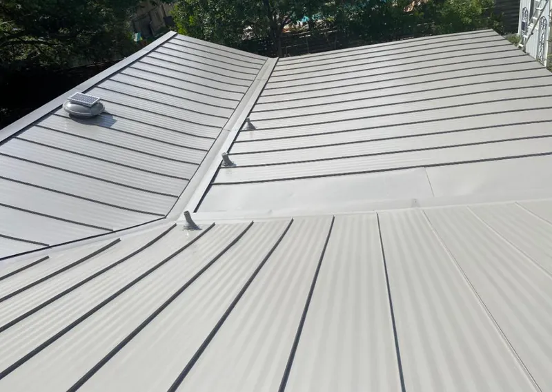 Solar attic fan installed on a metal roof for Roof Ventilation in Childress